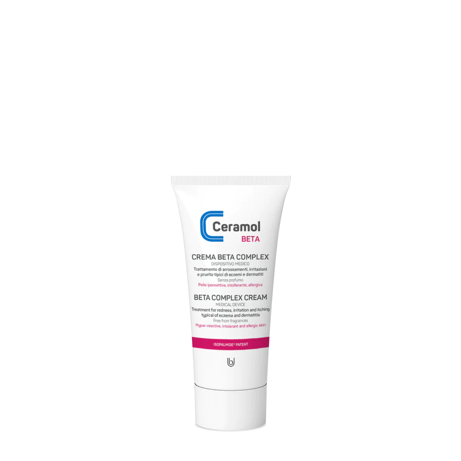 Eine weiße Tube CERAMOL BETA COMPLEX CREME von Hinterland Apotheke steht aufrecht auf weißem Grund, mit blauem und rosafarbenem Etikett und Flip-Top-Verschluss - ideal für Dermatitis Behandlung und Hautbarriere Wiederaufbau.